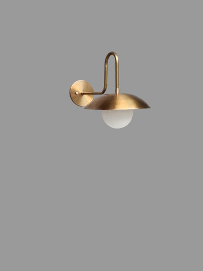 Handmade brass wall lamp with elegant globe shade | Frost Lights