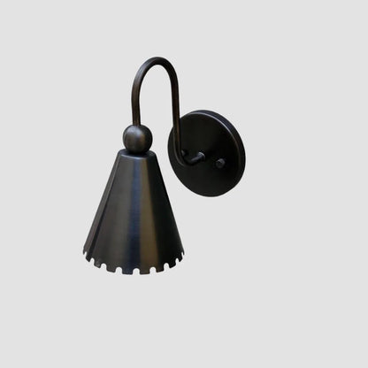 Black wall-mounted lamp with cone-shaped shade on a light gray background