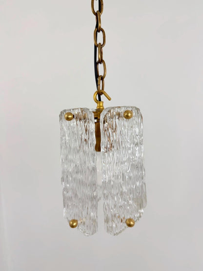 Clear textured glass hanging pendant light with polished brass hardware.