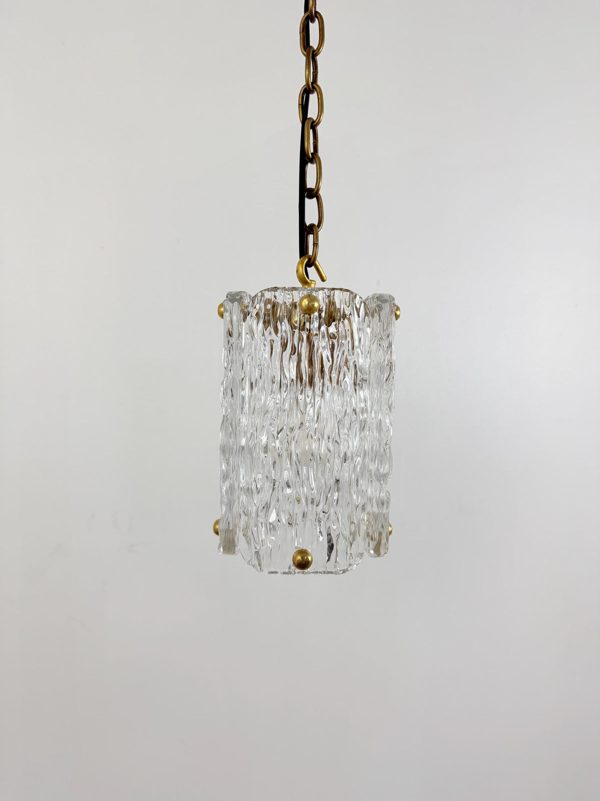 Frost Lights modern textured glass pendant hanging on chain.