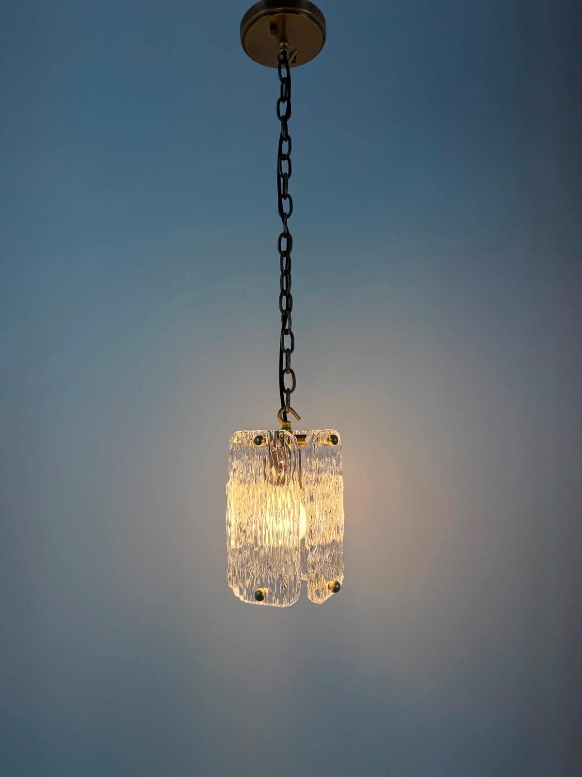 Frost Lights textured glass pendant lamp hanging from chain.