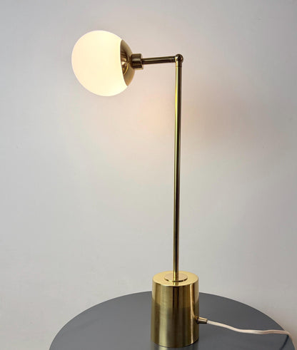 This Modern Brass Table Lamp Features an Opal White Glass Globe Positioned at The End of An Adjustable Arm, with A Narrow Brass Stem and Cylindrical Base Below. Its Clean Proportions Create a Refined Bedside or Desk Lighting Accent, Frost Lights.