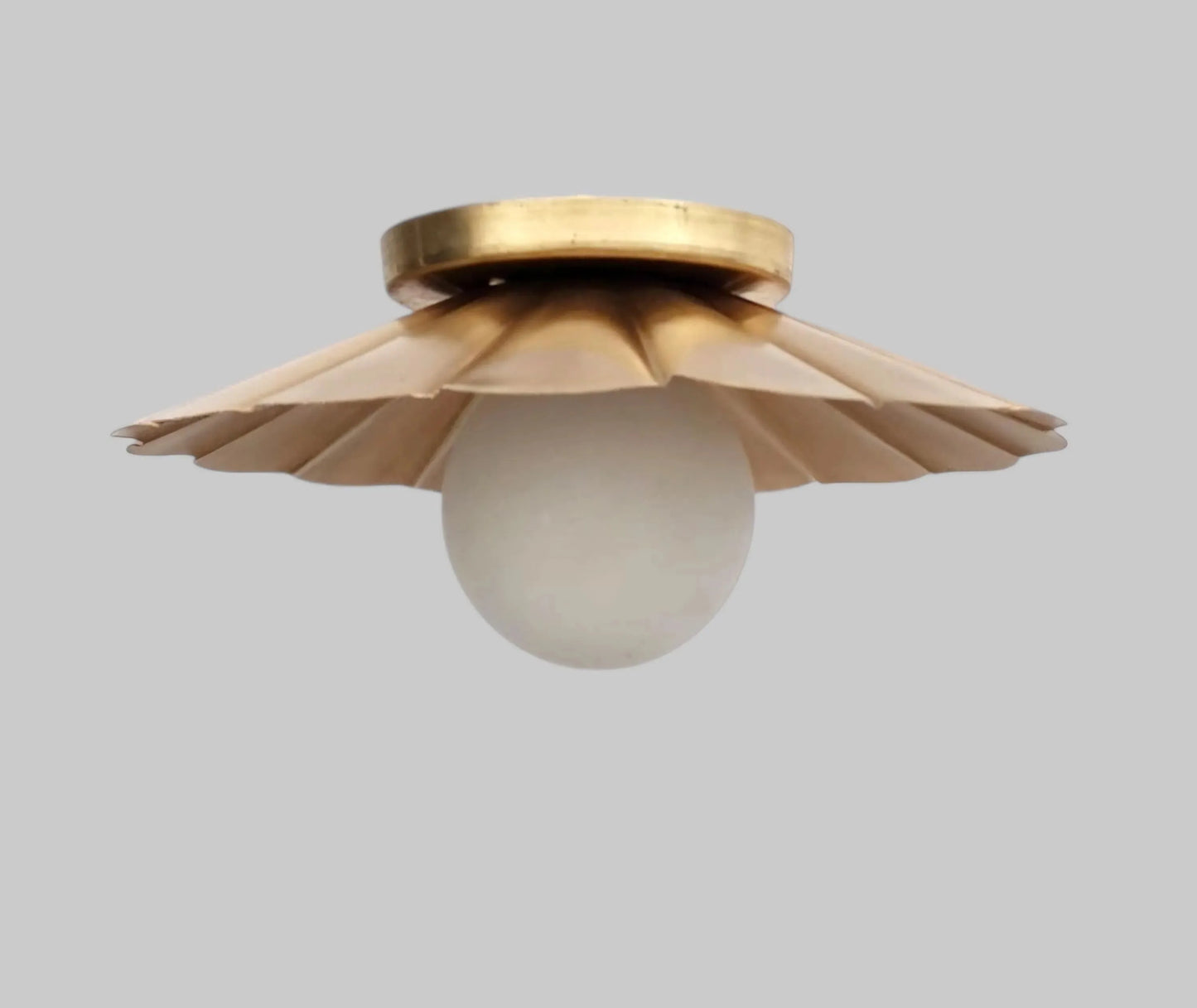 Vintage brass chandelier with a floral design and frosted glass globe, perfect for elegant ceiling lighting.
