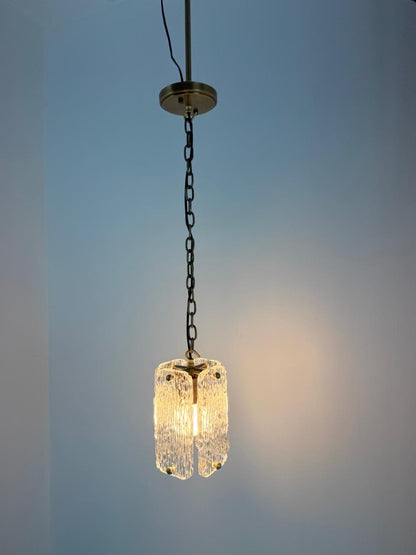 Stylish textured glass pendant ceiling light with brass trim and chain suspension.