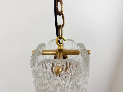 Stylish textured glass pendant ceiling light with brass trim and chain suspension.