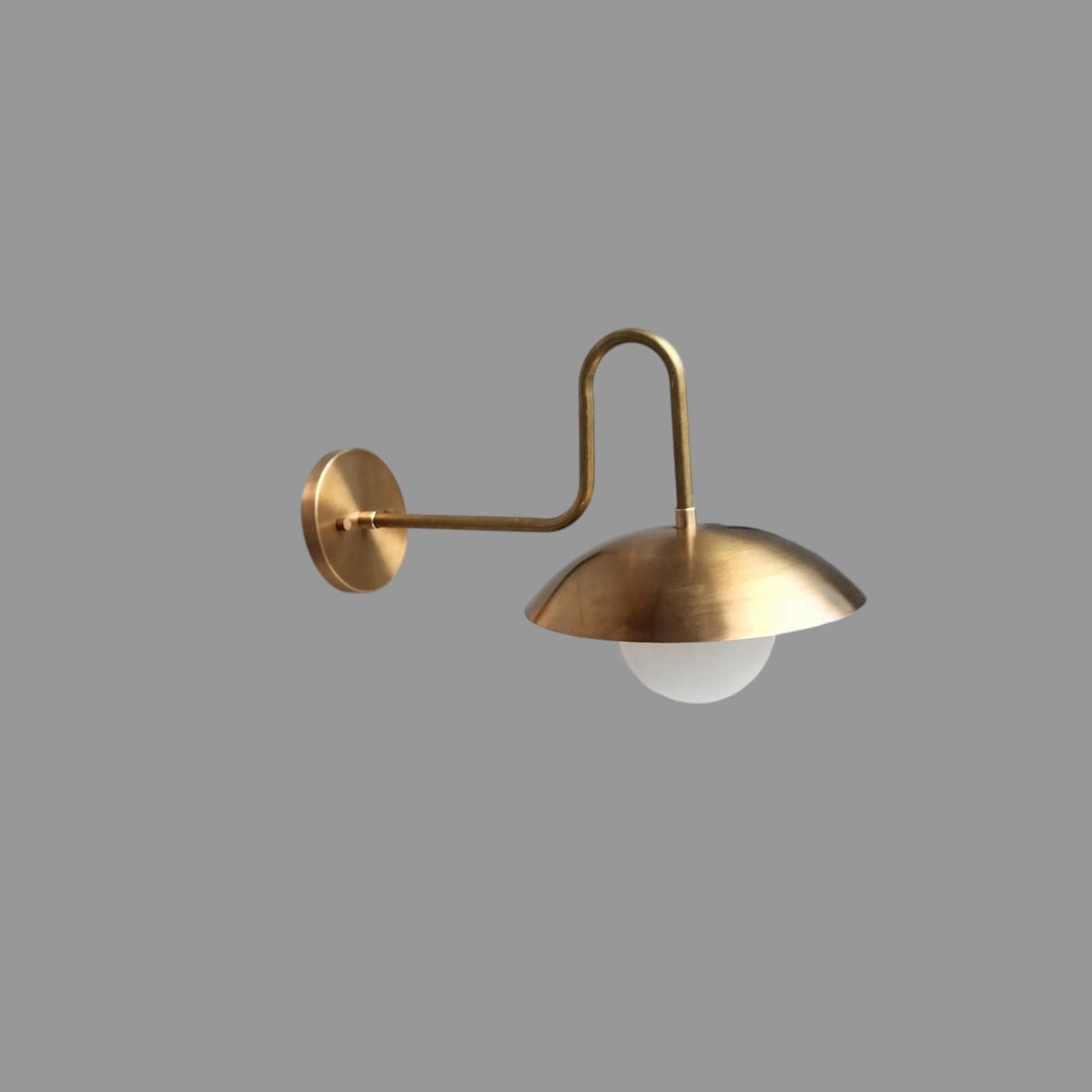 Vintage brass wall light with round white glass shade | Frost Lights